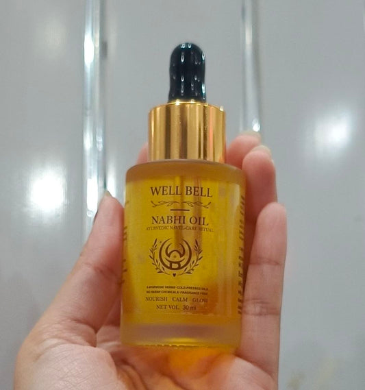 Well Bell Nabhi Oil 30ml dropper bottle held in hand